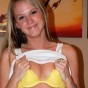 Cali lifts her shirt to show off her perky tits in a bright yellow lace bra
