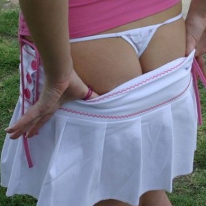 Amy flashes her ass and tiny thong out in a public park