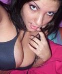 Nikki takes pictures of herself in a black tiny bra which her tits are almost falling out of