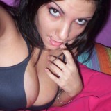 Nikki takes pictures of herself in a black tiny bra which her tits are almost falling out of