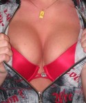 Carmas huge tits are almost popping out of her bright red bra