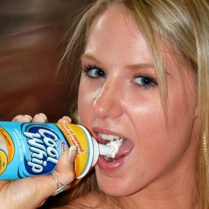 Topless teen puts whipcream on her perky tits