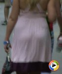 Hot girl in a summer dress walking down the street