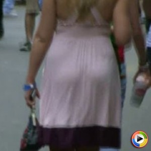 Hot girl in a summer dress walking down the street