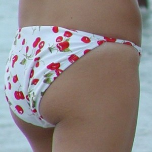 Teens in bikinis tanning at the beach
