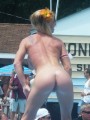 Naked strippers showing off on an outdoor stage