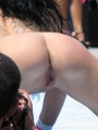 Stripper on outdoor stage shows her tight pussy to the crowd