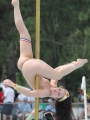 Strippers showing off their skills on the pole at an outdoor party