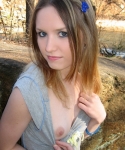 Cute teen Shelby flashes her perky tit while at the park down by the creek